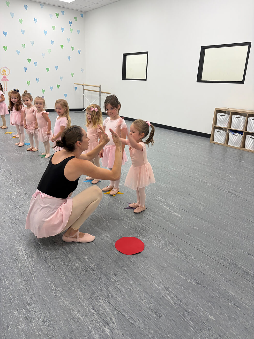 Tempo instructor high-fiving a toddler in early childhood ballet class