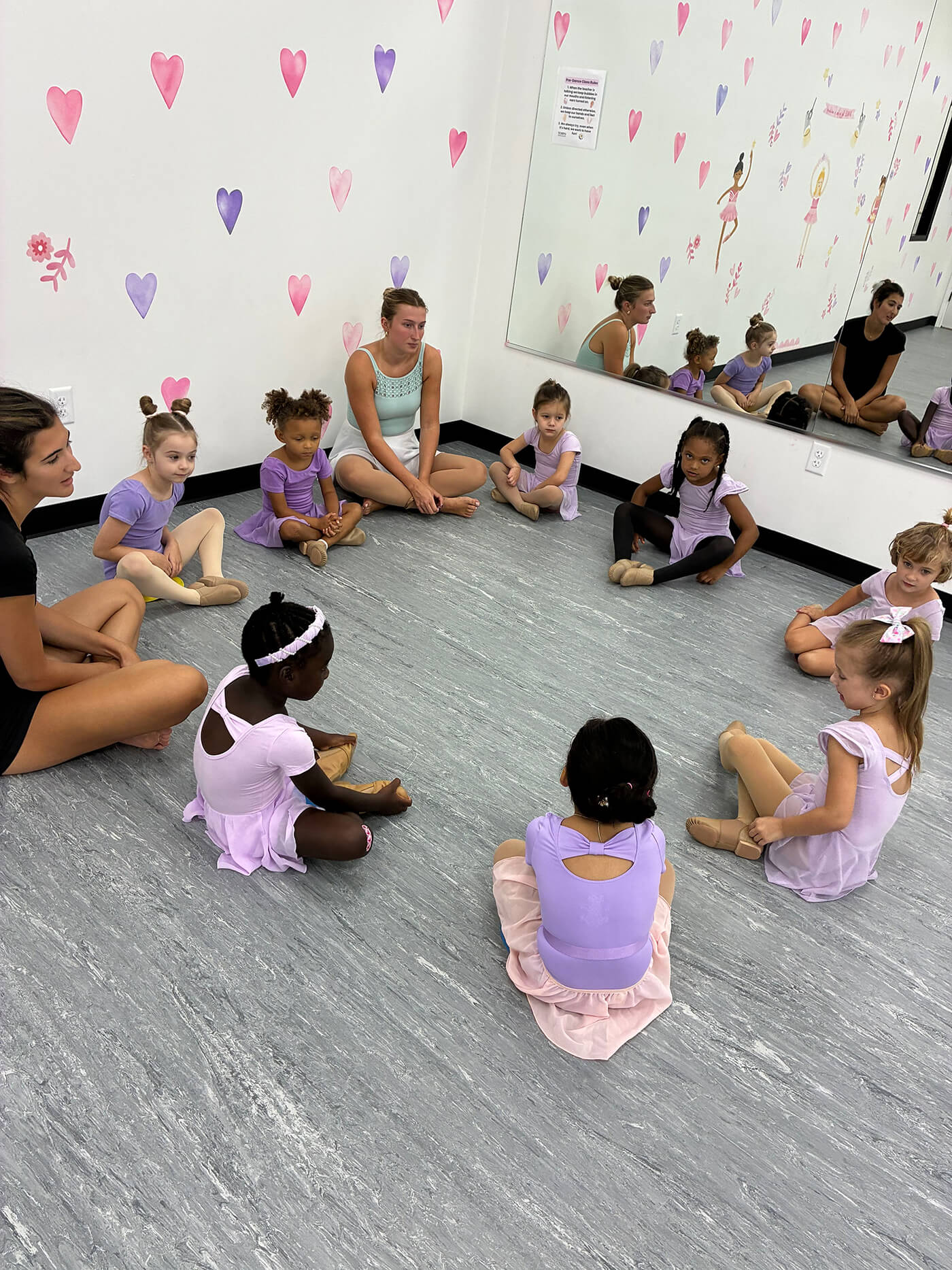Young dancers and instructors sitting in a circle during an early childhood class at Tempo